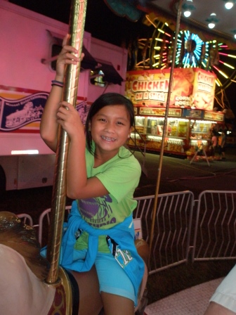 Kasen riding the carousel
